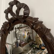 Antique oval mirror in carved wood and Louis XVI style knot