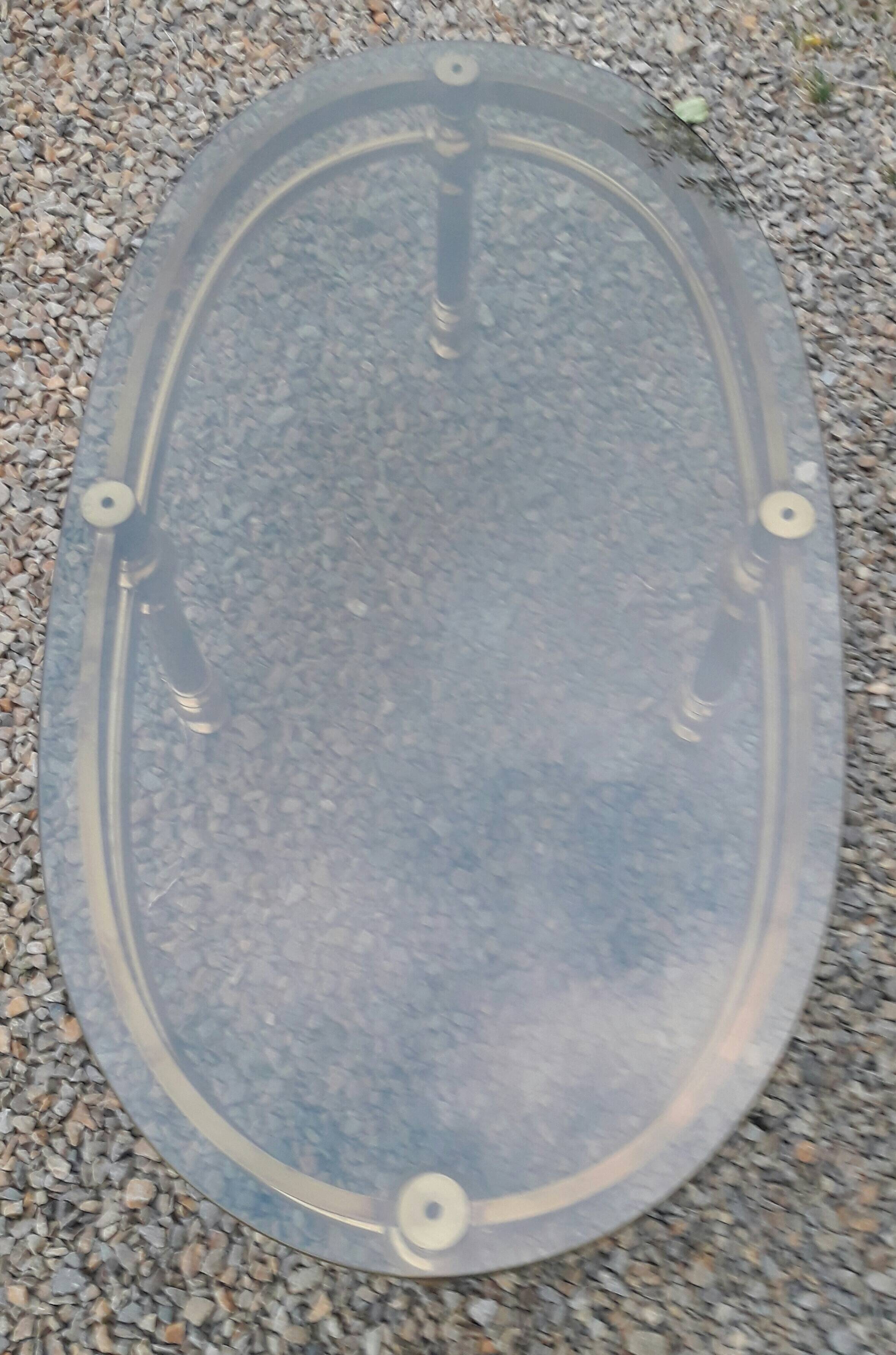 Oval coffee table in gilded brass and smoked glass 1970