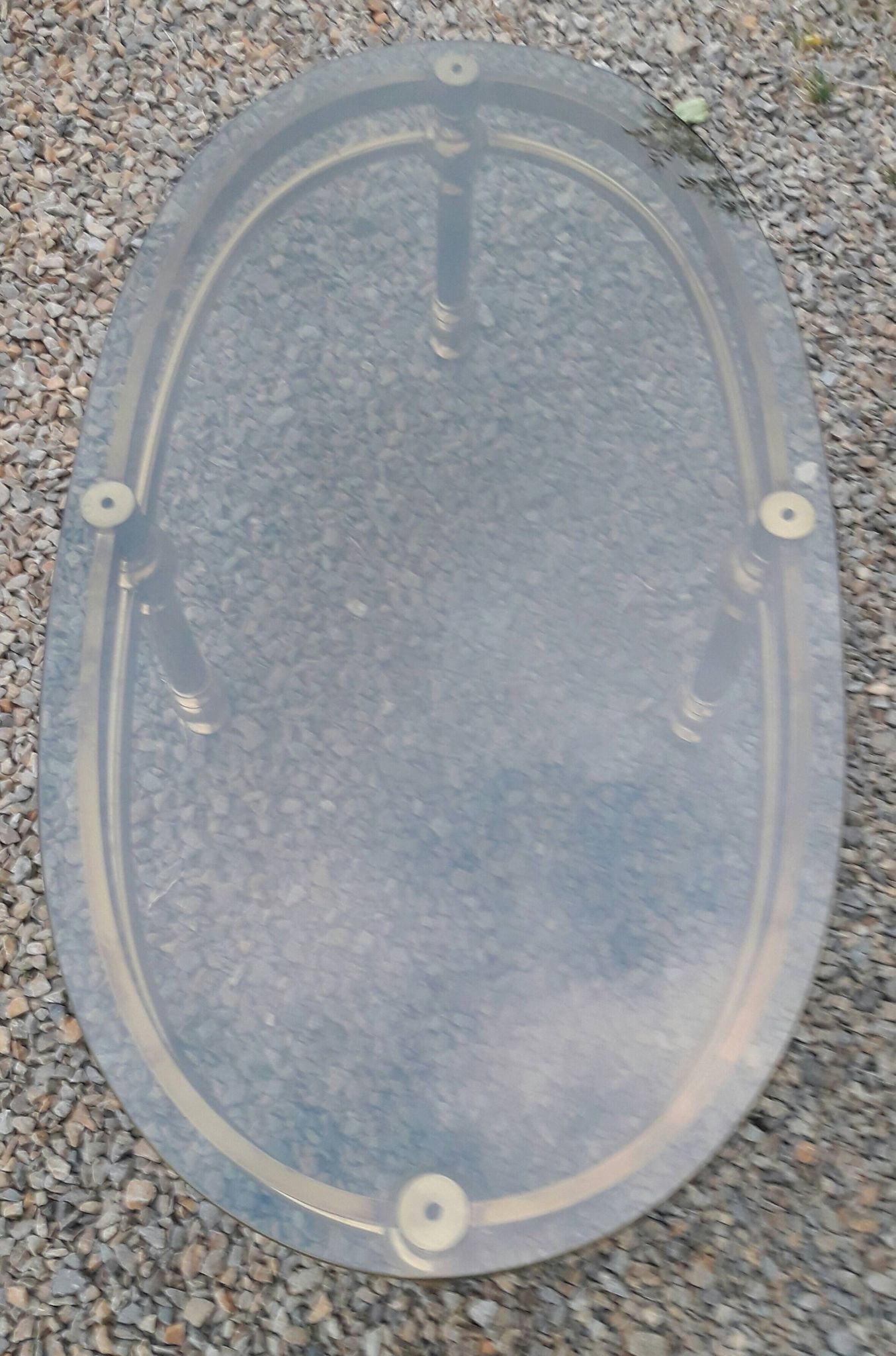 Oval coffee table in gilded brass and smoked glass 1970