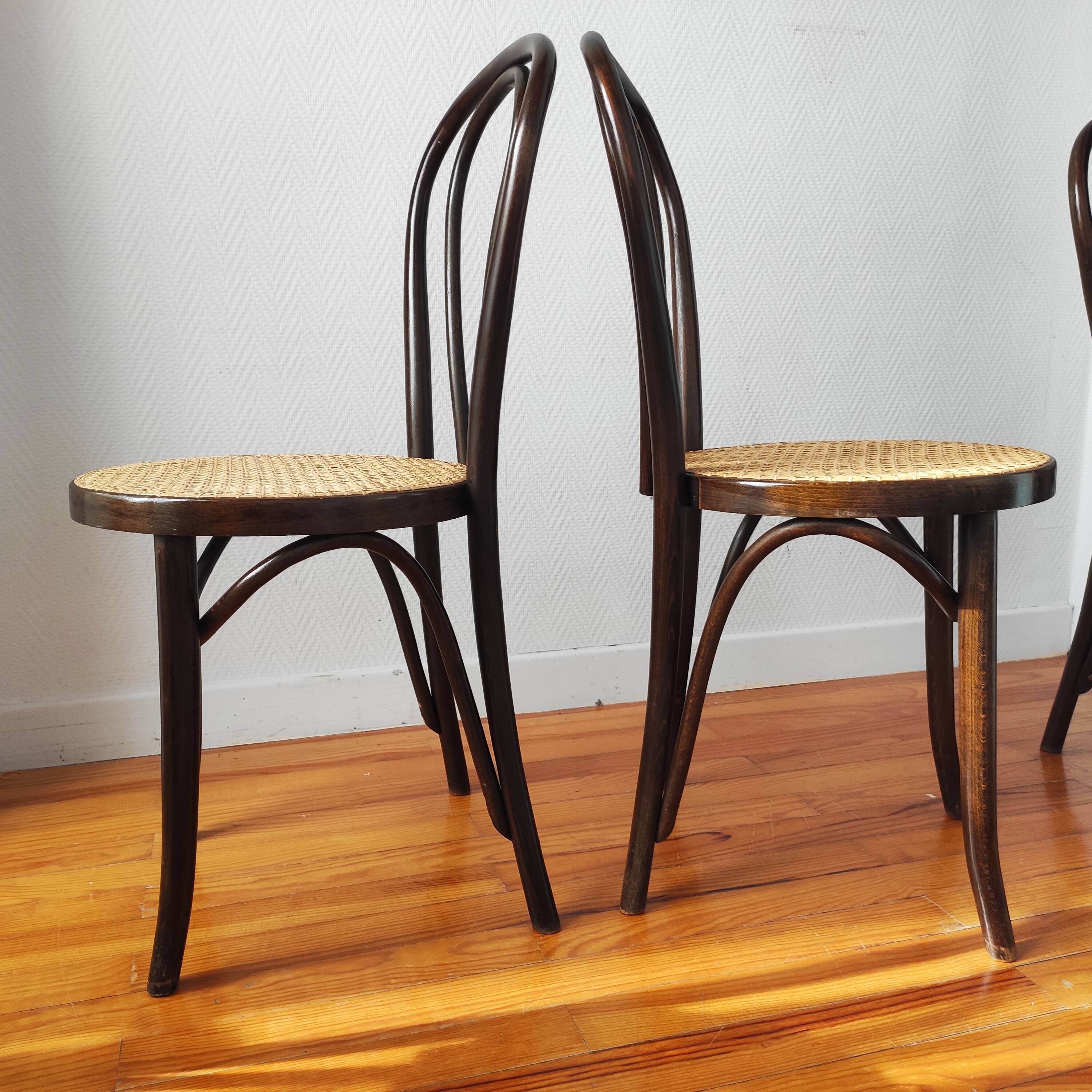 4 antique curved wood and cane chairs