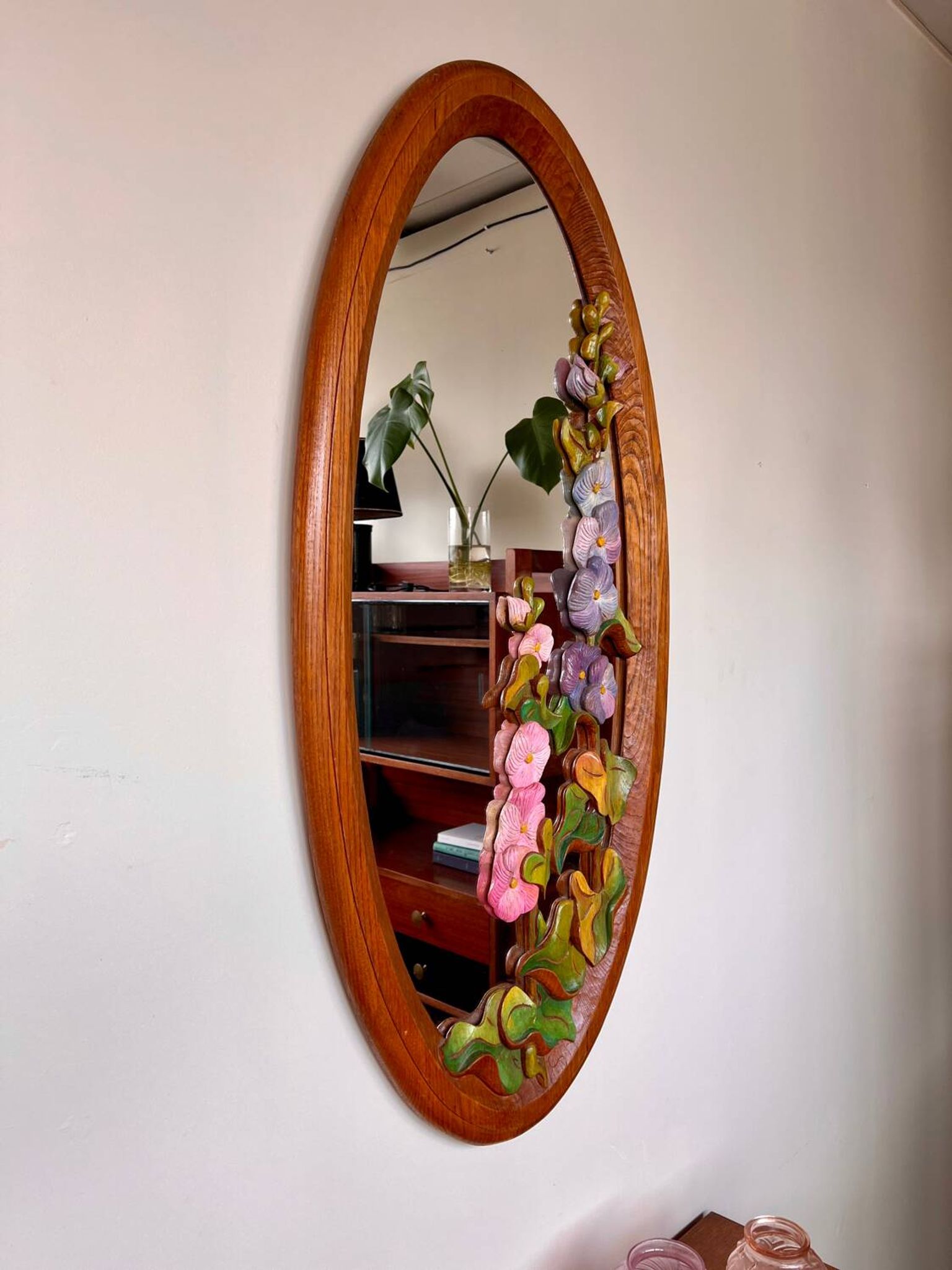 Carved wooden mirror with flower decorations.