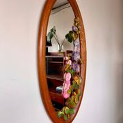 Carved wooden mirror with flower decorations.