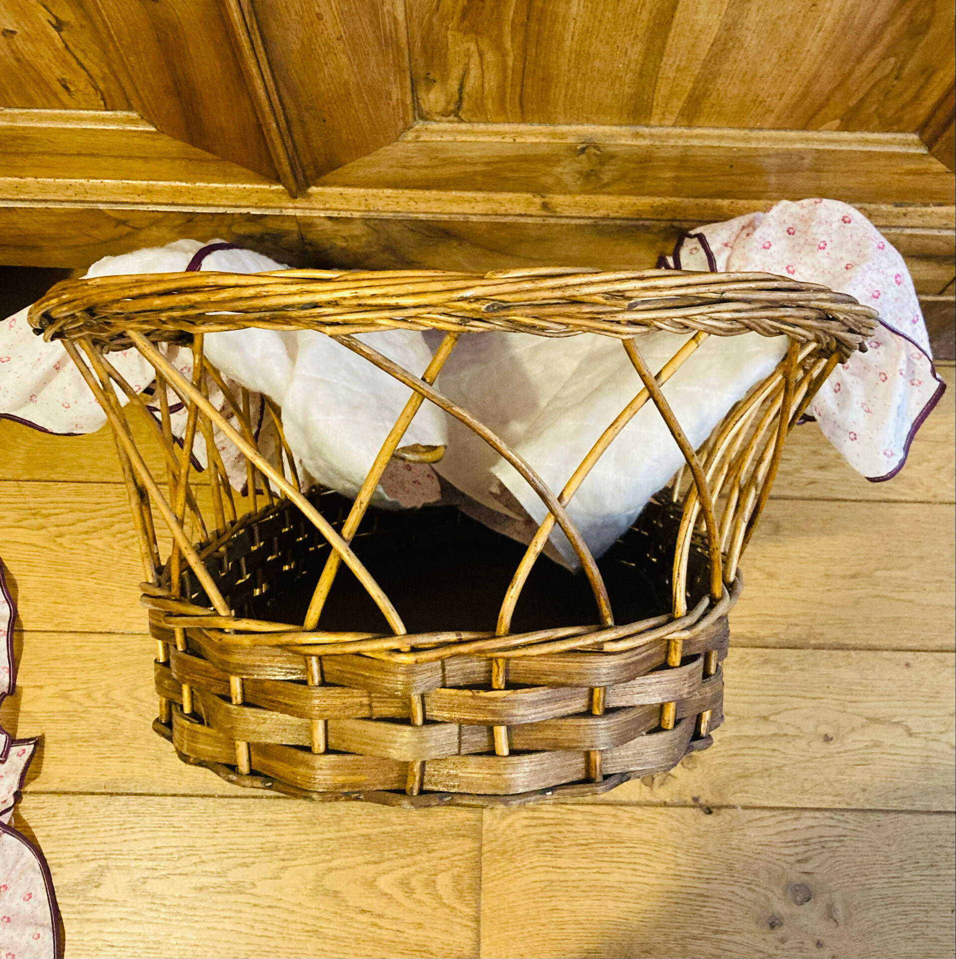 1960s wicker cradle with mattress and drapes.
