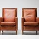 Pair of Art Deco armchairs in brown leather and teak, Netherlands, 1970s.