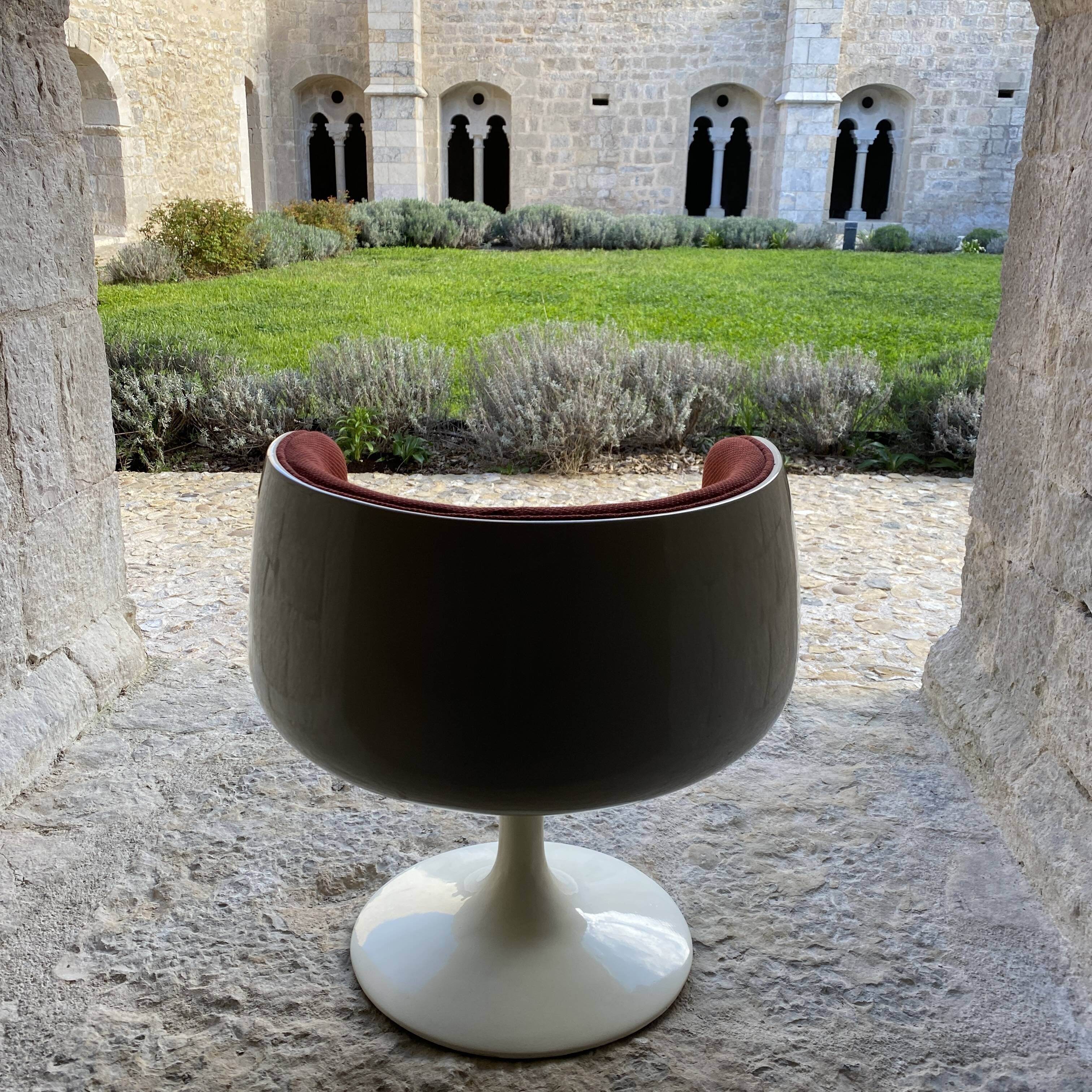 Two cognac-colored swivel chairs made of fiberglass from the 1970s