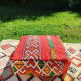 Handwoven floor pouf in natural wool