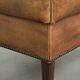 Cowhide ottoman with a beautiful patina finished with decorative nails