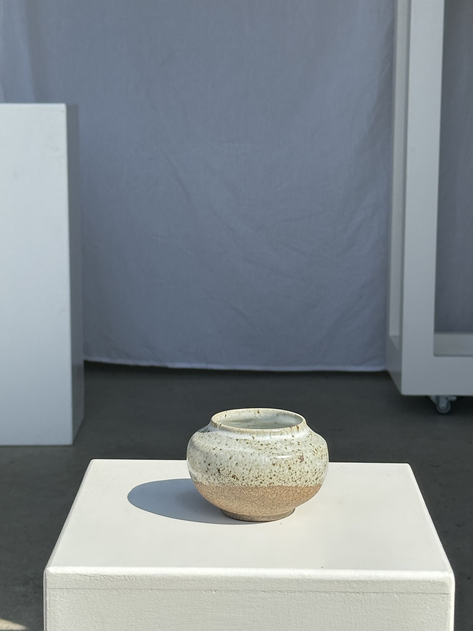 Small white ball vase tight neck in glazed speckled ceramic