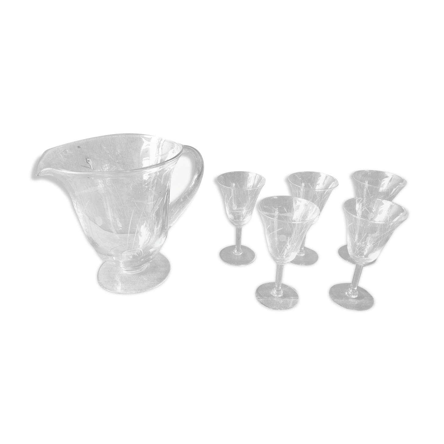 Old pitcher service and 5 foot glasses in engraved glass vintage table art