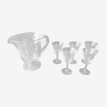 Old pitcher service and 5 foot glasses in engraved glass vintage table art