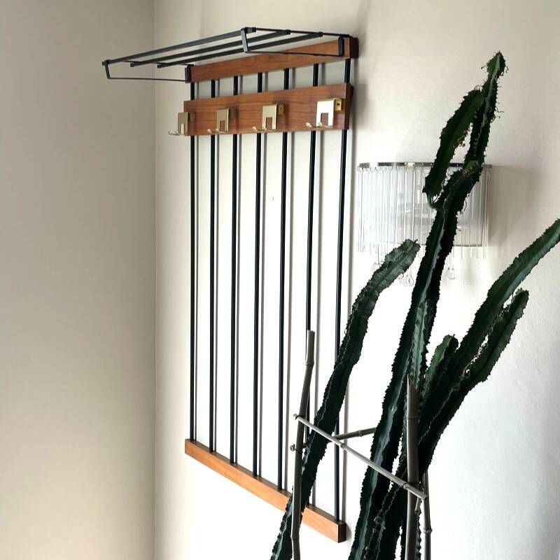 Wall-mounted coat rack in wood and black.