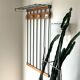 Wall-mounted coat rack in wood and black.