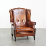 Sheepskin Wingback Chair with Warm Tones and Black Piping