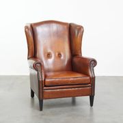 Sheepskin Wingback Chair with Warm Tones and Black Piping