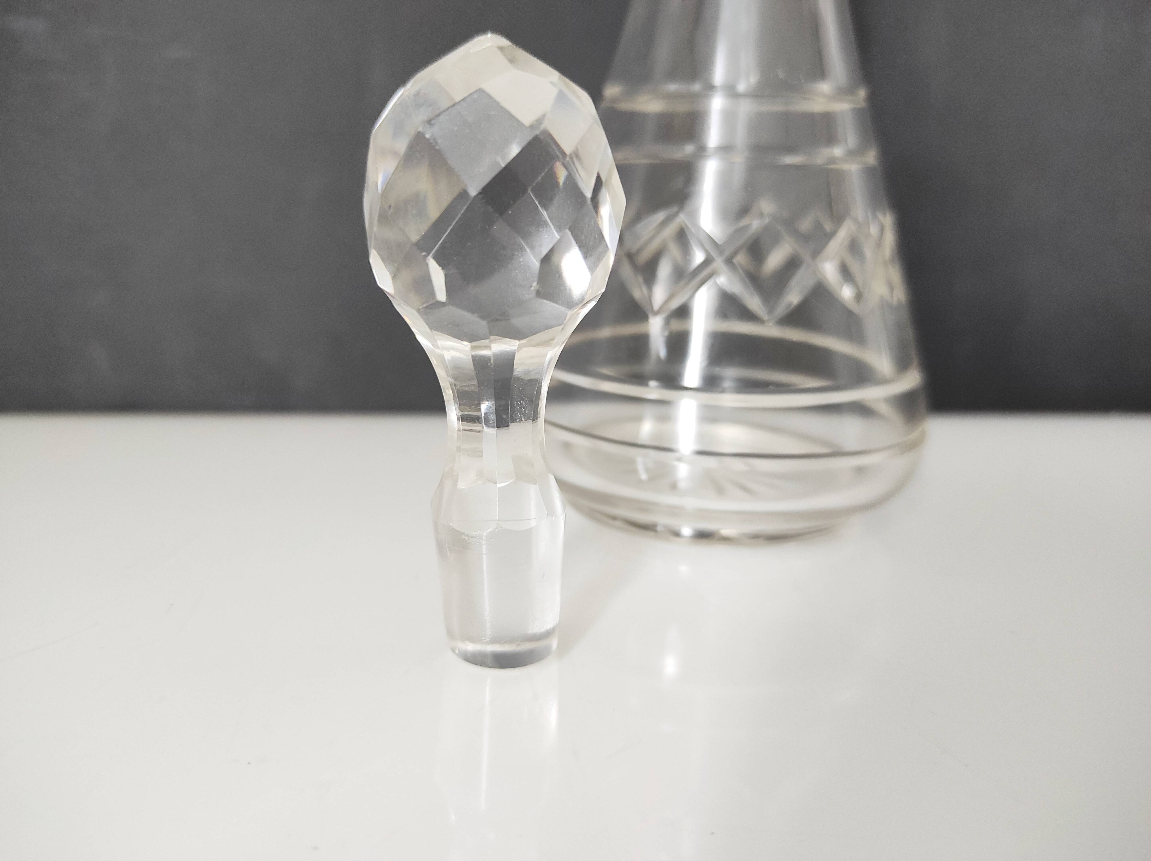 Crystal bottle with silver metal neck rim