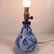Antique table lamp in opaline glass with blue floral decoration.