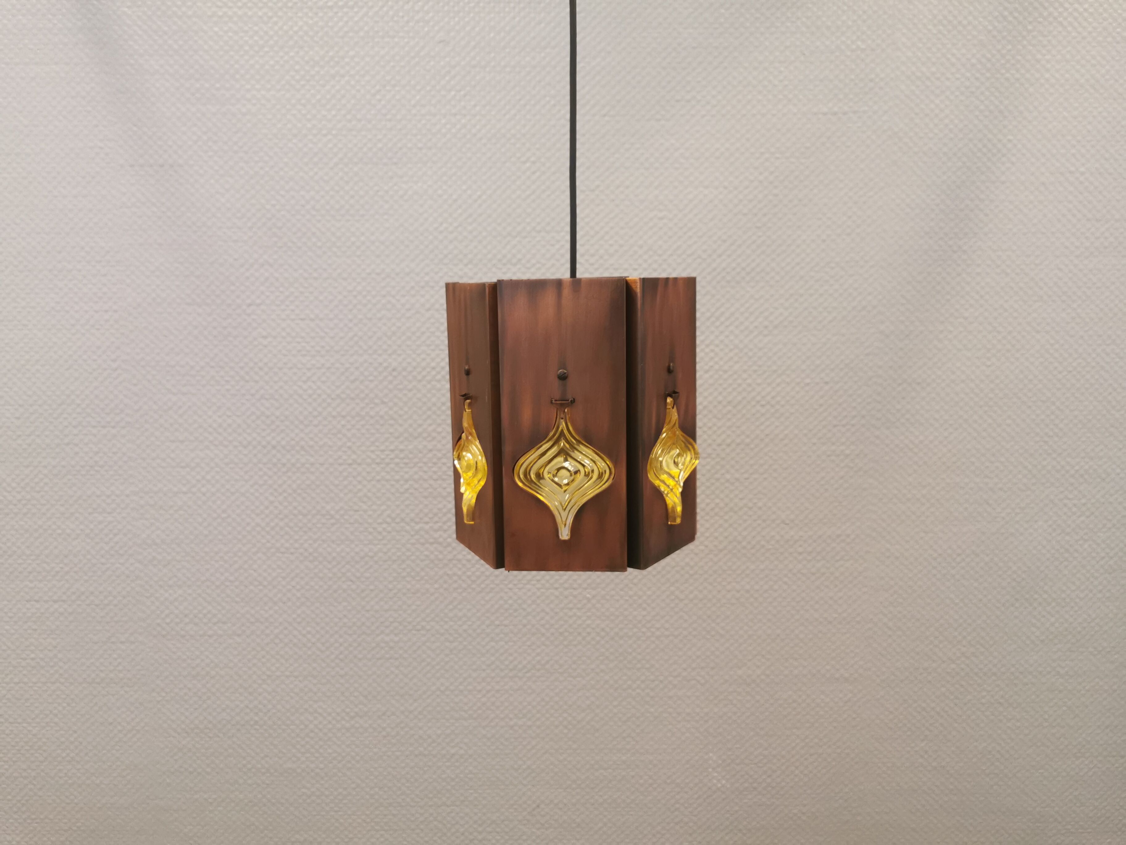 Older hanging lamp, made of metal with yellow prisms.
