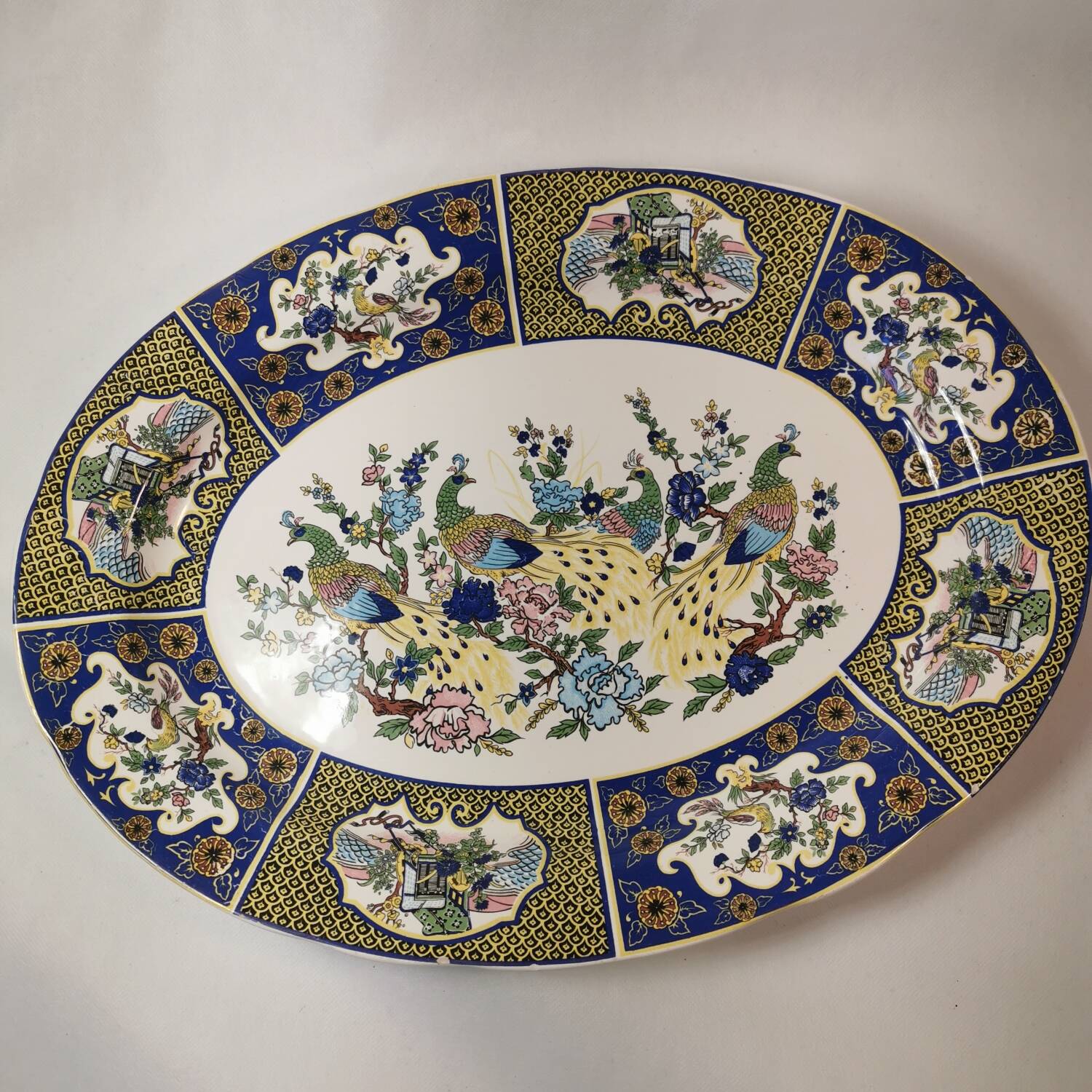 Ceramic dish decorated with peacock folk art Asian motif