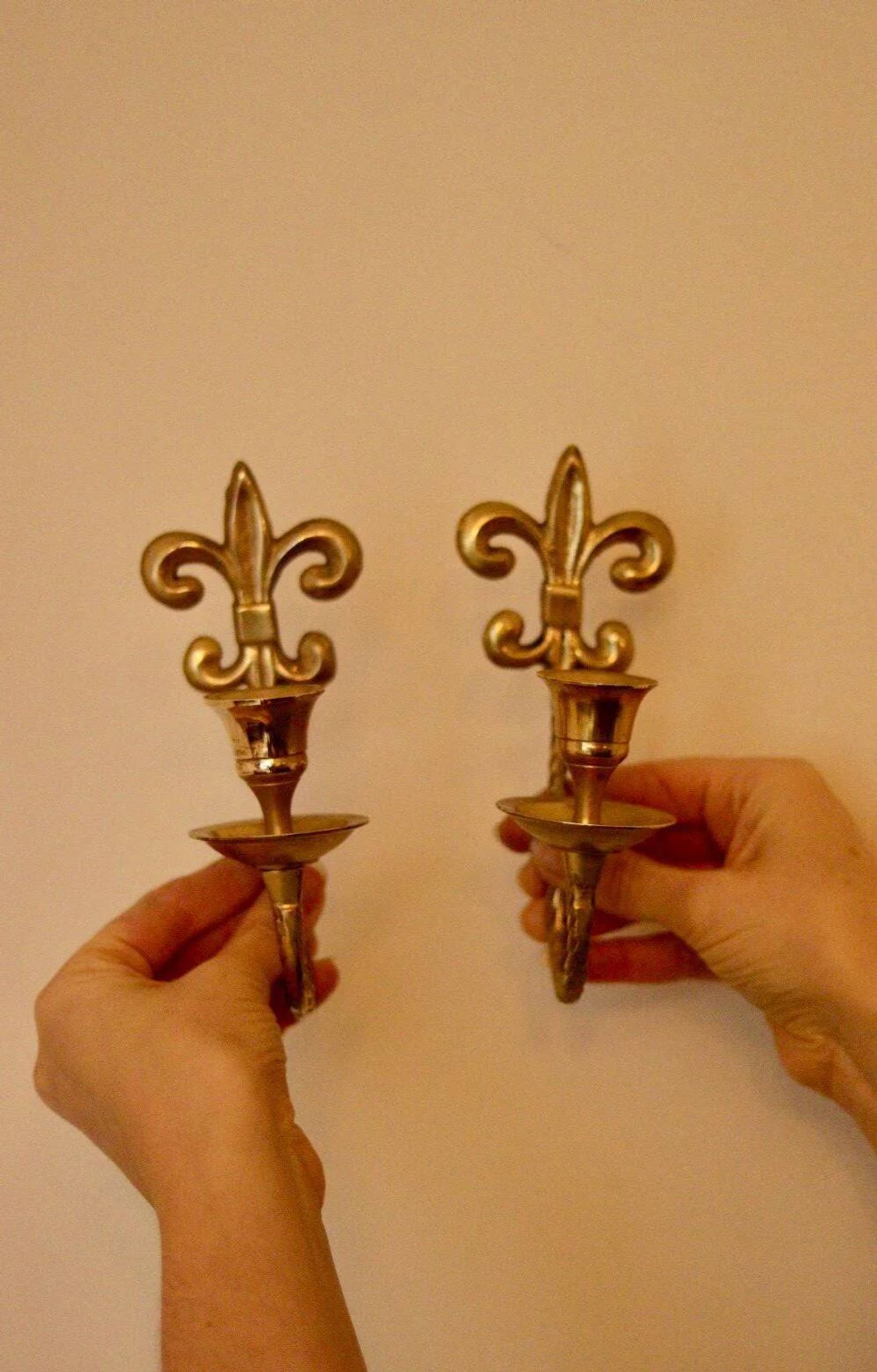 A pair of antique brass wall sconces.