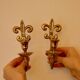 A pair of antique brass wall sconces.