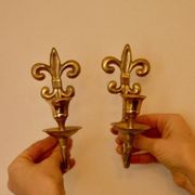 A pair of antique brass wall sconces.