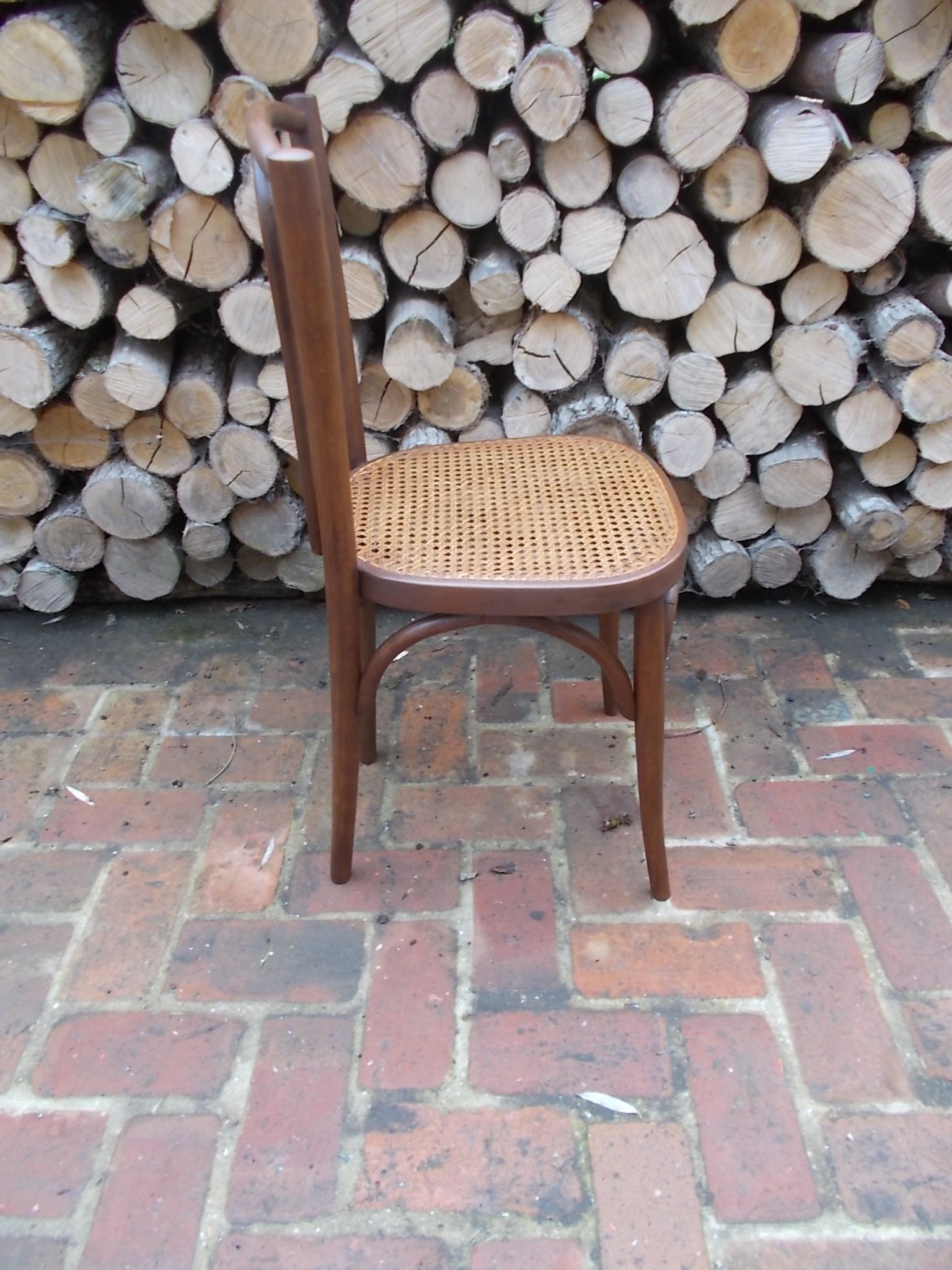 Curved wooden bistro chair with caning