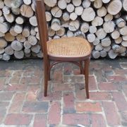 Curved wooden bistro chair with caning