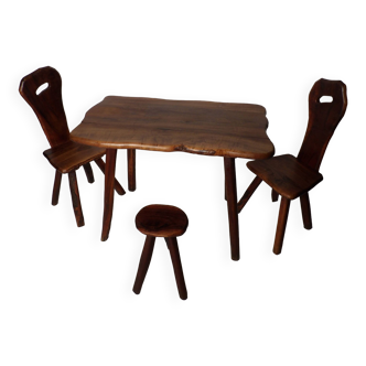 Table and two chairs and an olive stool