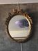 Oval golden mirror