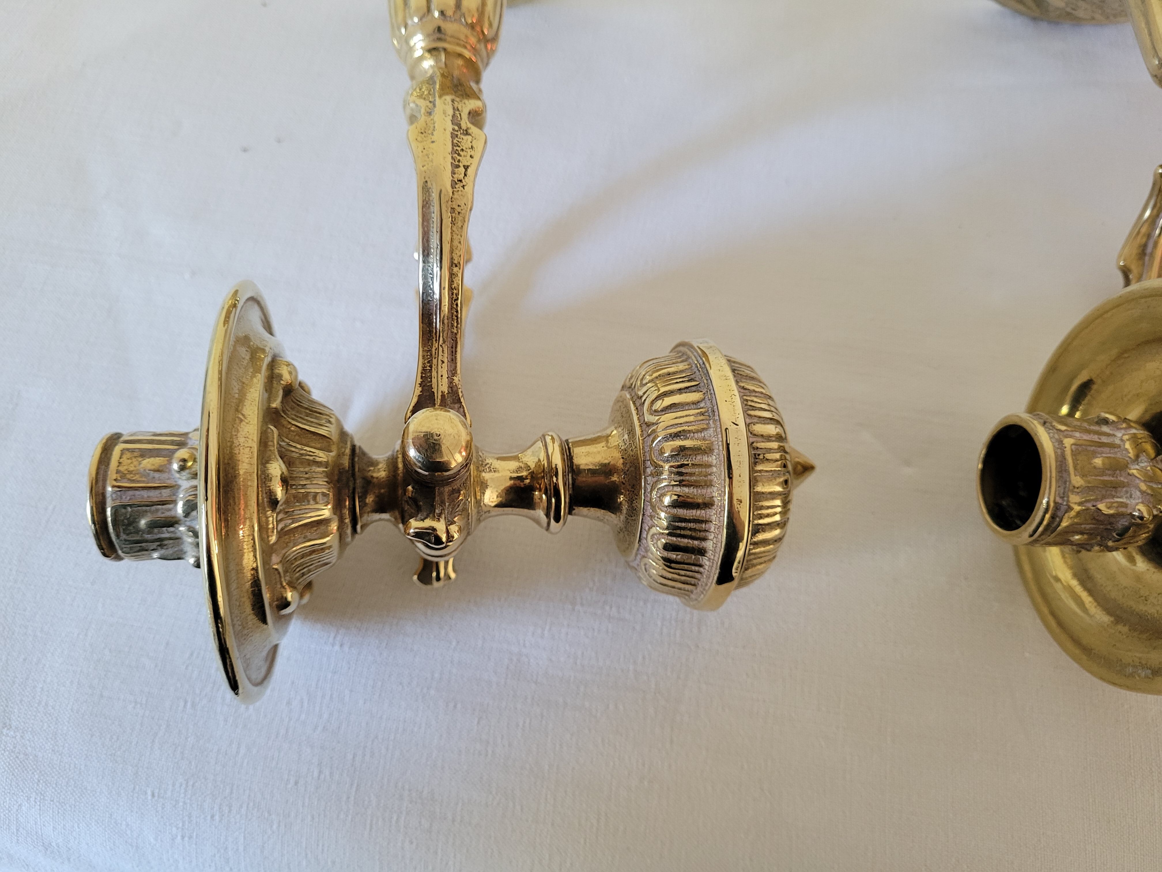 Duo of brass balance wall candle holders