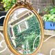 Miroir ovale biseauté en bois doré vintage 46x62cm