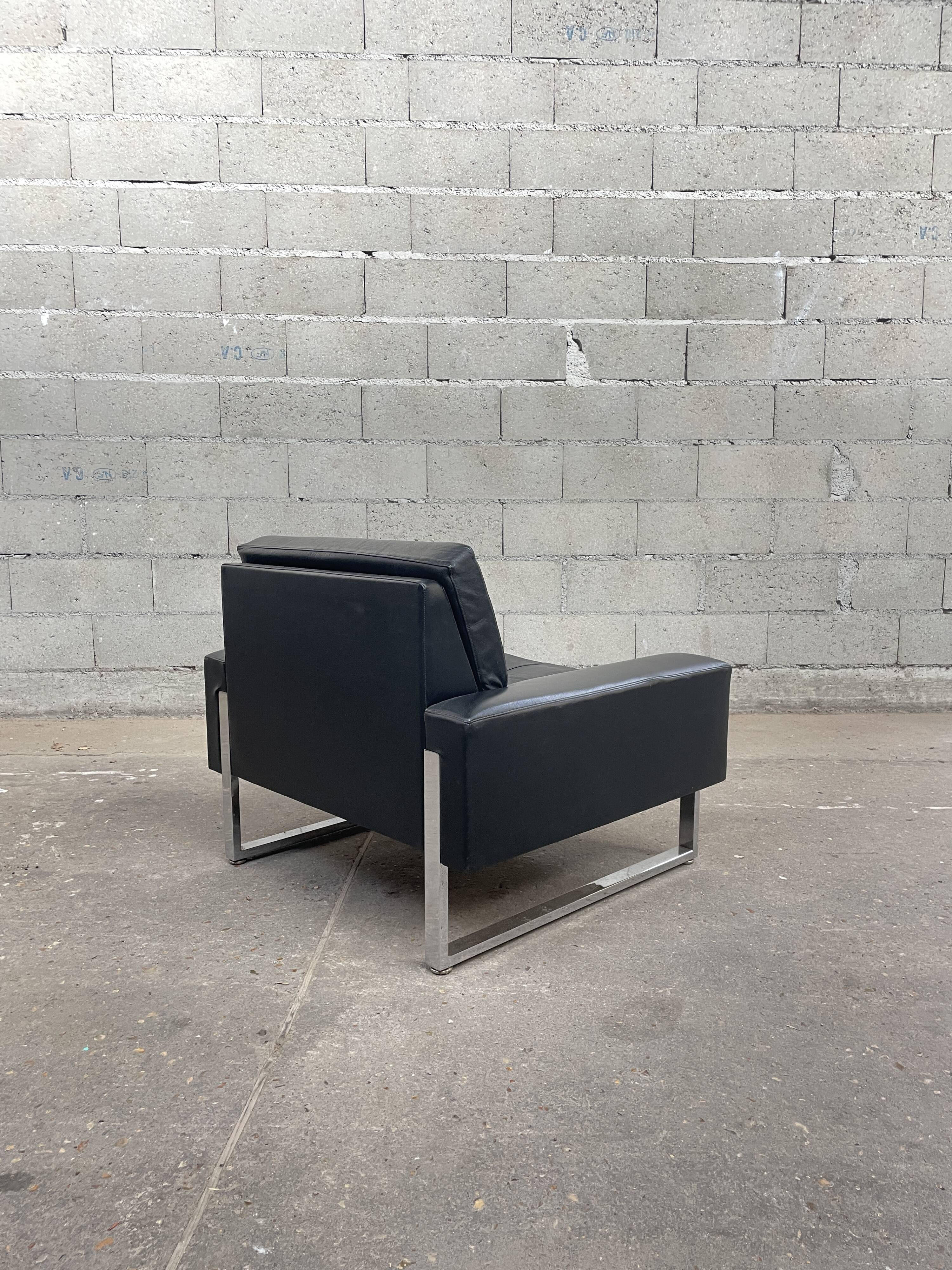 Pair of black leather armchairs