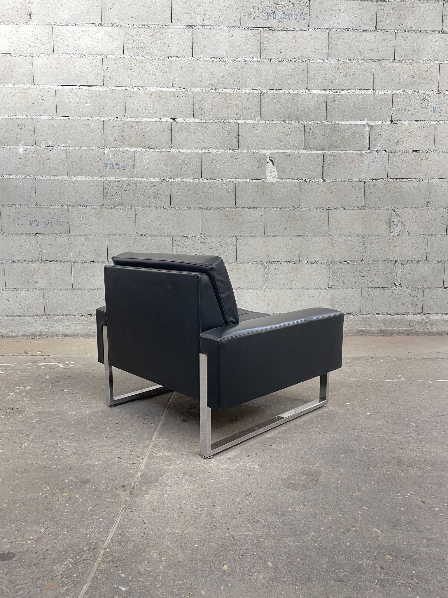 Pair of black leather armchairs