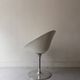 Ero swivel armchair in metal and white shell, p. starck design for kartell