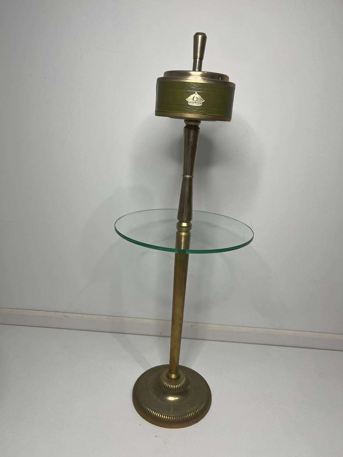 Vintage brass floor ashtray with glass shelf in Empire style.