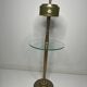 Vintage brass floor ashtray with glass shelf in Empire style.