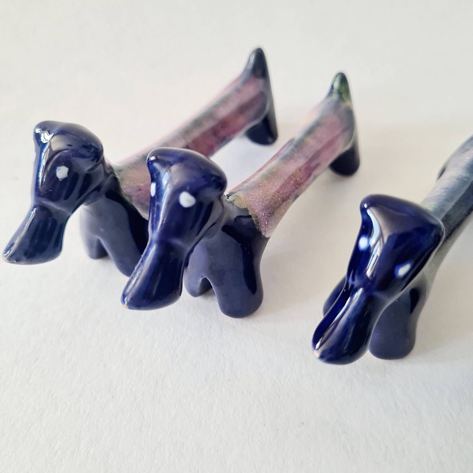 Set of 8 vintage ceramic knife rests, retro dog design.