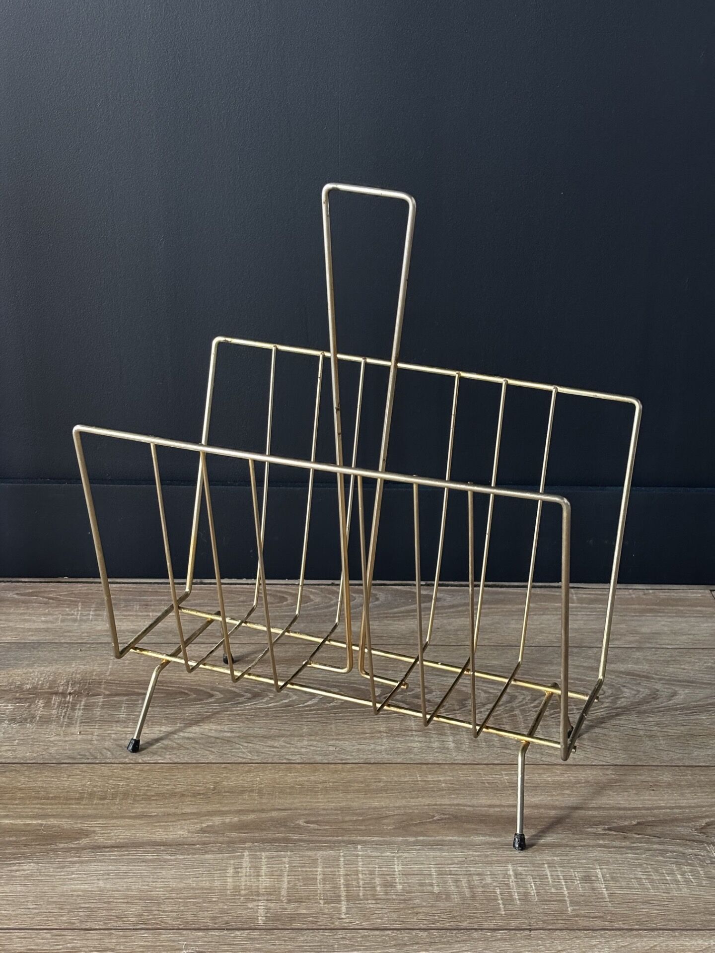 Mid-century magazine rack in golden metal wire