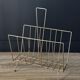 Mid-century magazine rack in golden metal wire