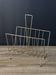 Mid-century magazine rack in golden metal wire