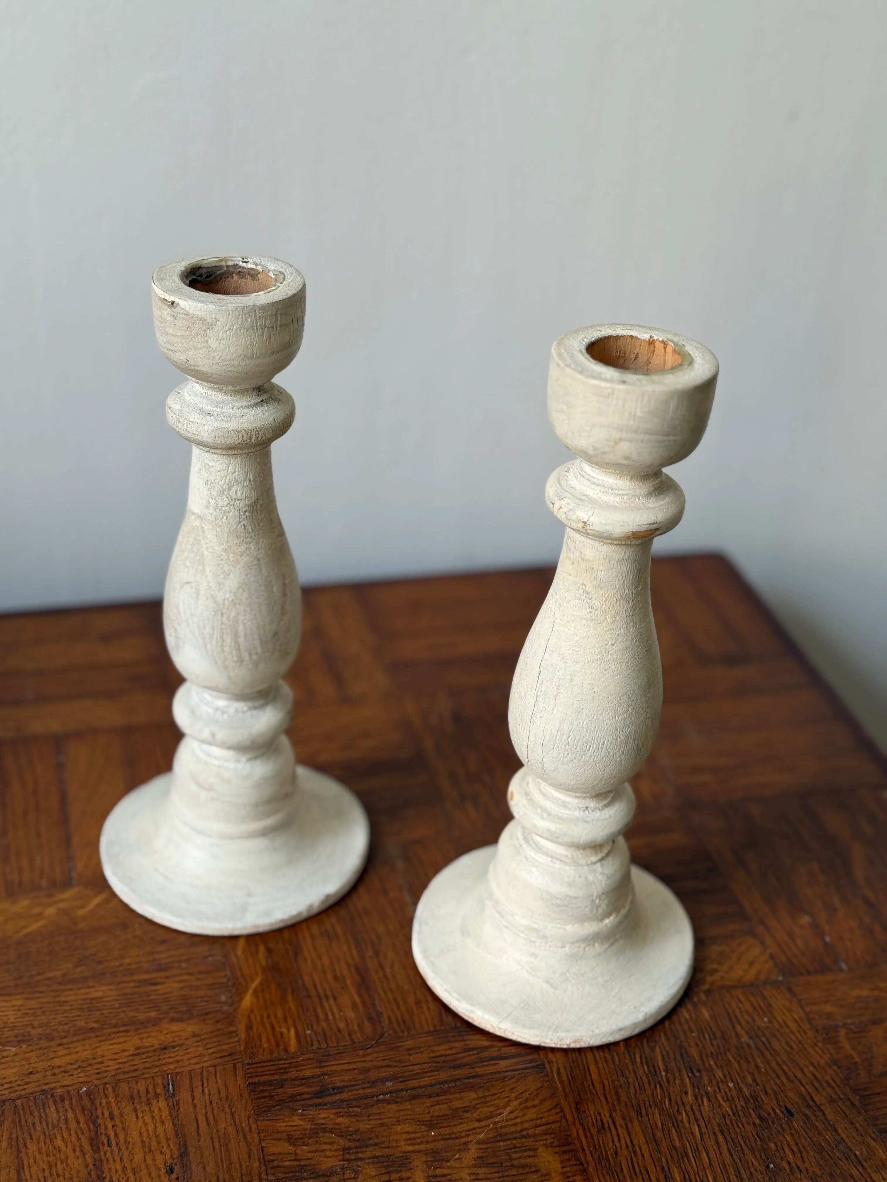 Pair of white wooden candlesticks