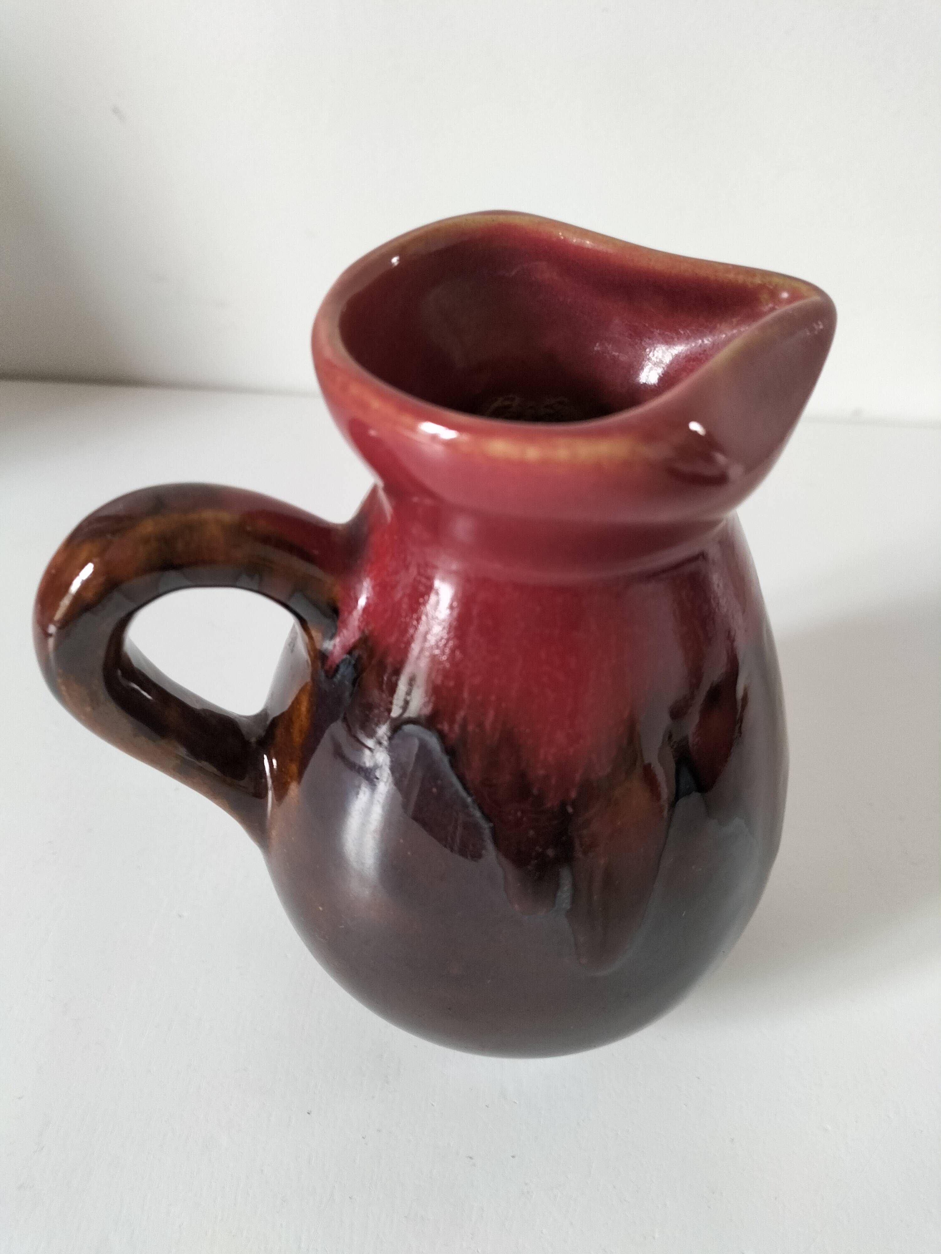 Vintage pitcher in raspberry red and chocolate flamed ceramic.