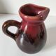 Vintage pitcher in raspberry red and chocolate flamed ceramic.