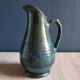 Vintage ceramic pitcher vase in glazed green and blue.