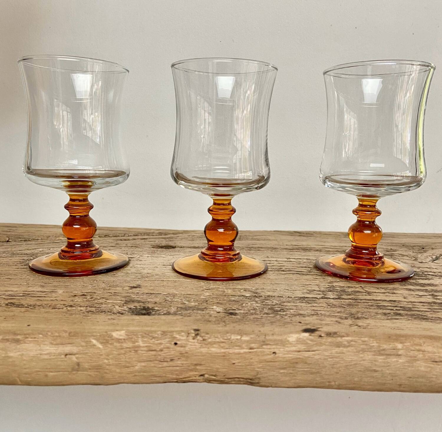 6 small amber stemmed glasses