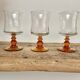6 small amber stemmed glasses