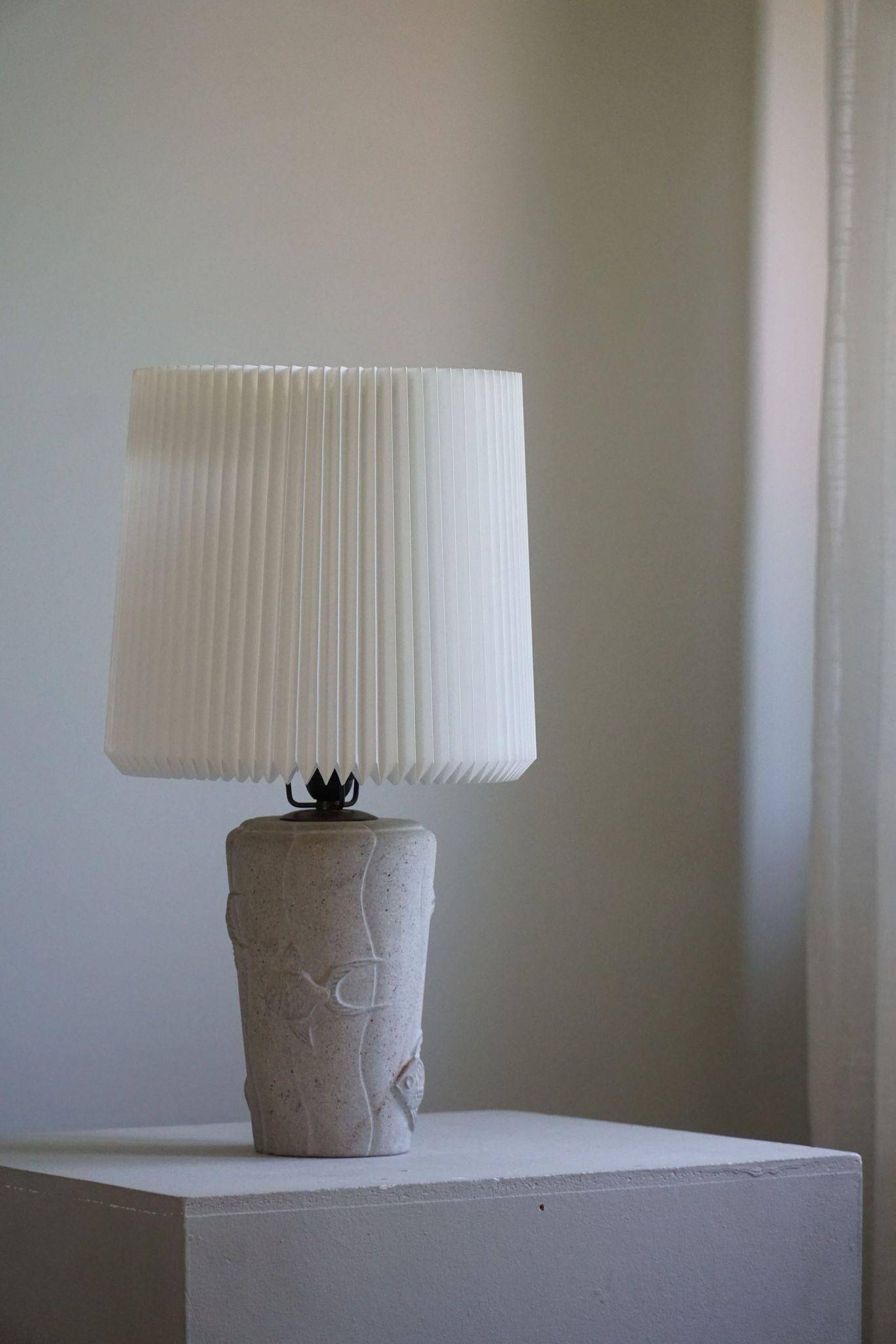 Modern vintage French table lamp, made of stone with fish patterns, 1970s.