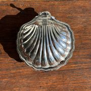 Vintage silver-plated shell butter dish with blue bowl.