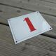 Enamelled metal plate street number