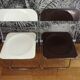 Duo of white and brown Piretti plia chairs